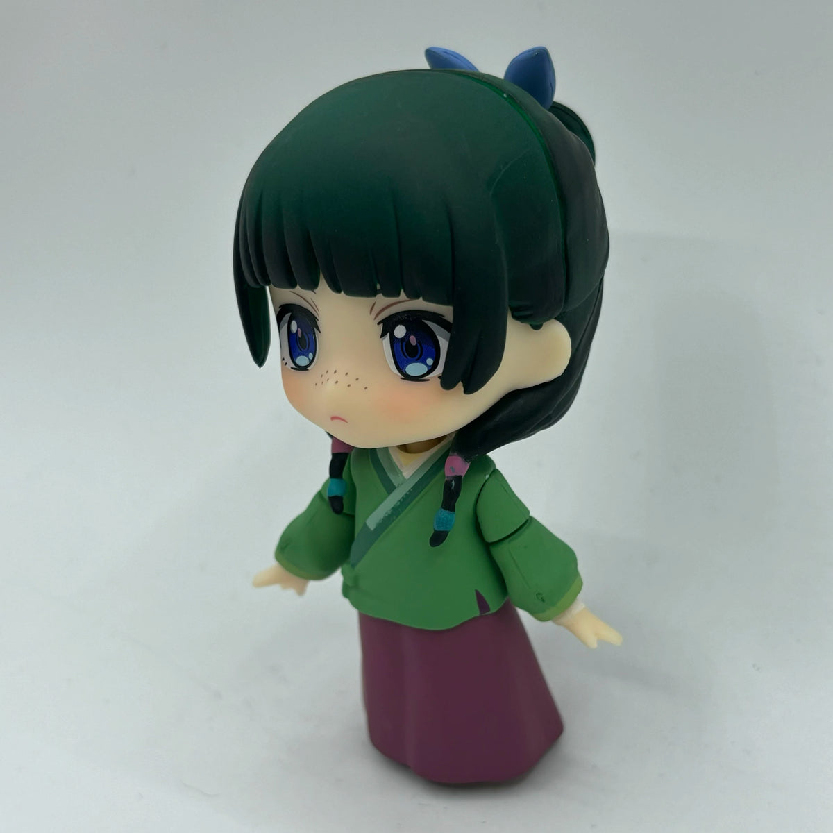 Maomao chibi figure three-quarter view with green top and purple skirt