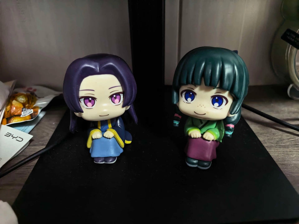 Maomao and Jinshi sitting figures displayed together on a desk
