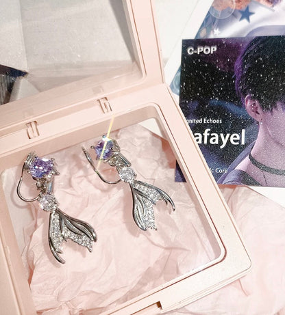 Close-up of the S925 silver needle on the Qi Yu fishtail earring showing the high-polish finish.