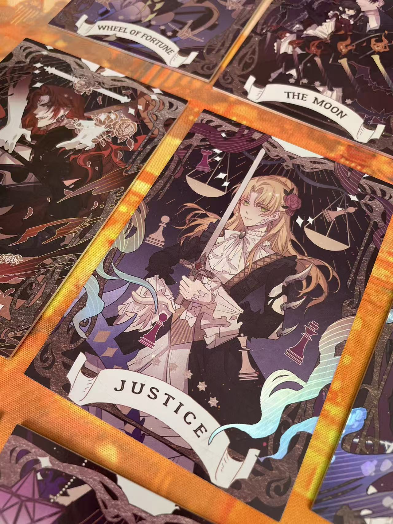 Lord of the Mysteries Paradox Starry Raven tarot card set Moon Justice and Chariot card close-up