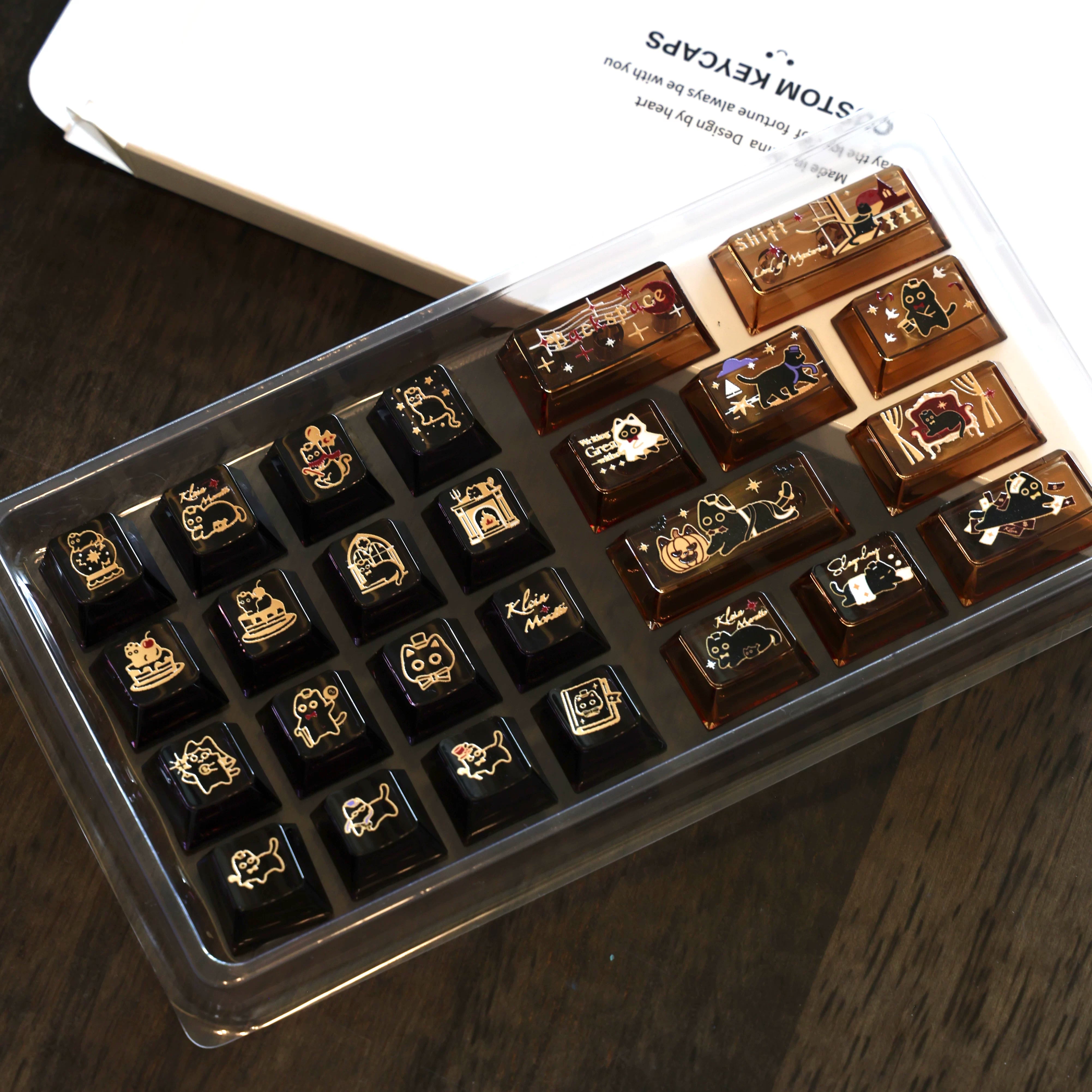 Amber transparent cat accent keycaps with illustrated scenes