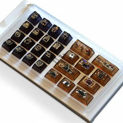 Cat-themed transparent PC keycaps displayed in a storage tray