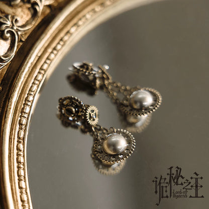 Sharon series faux pearl steampunk earrings close-up on mirror