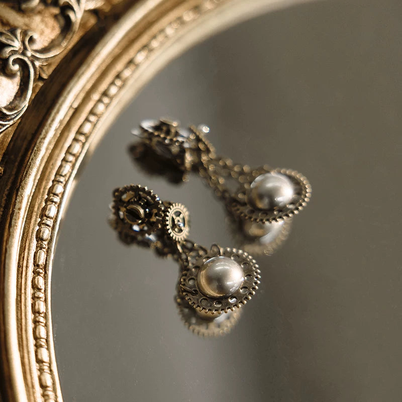 Sharon series faux pearl earrings close-up with antique bronze gears