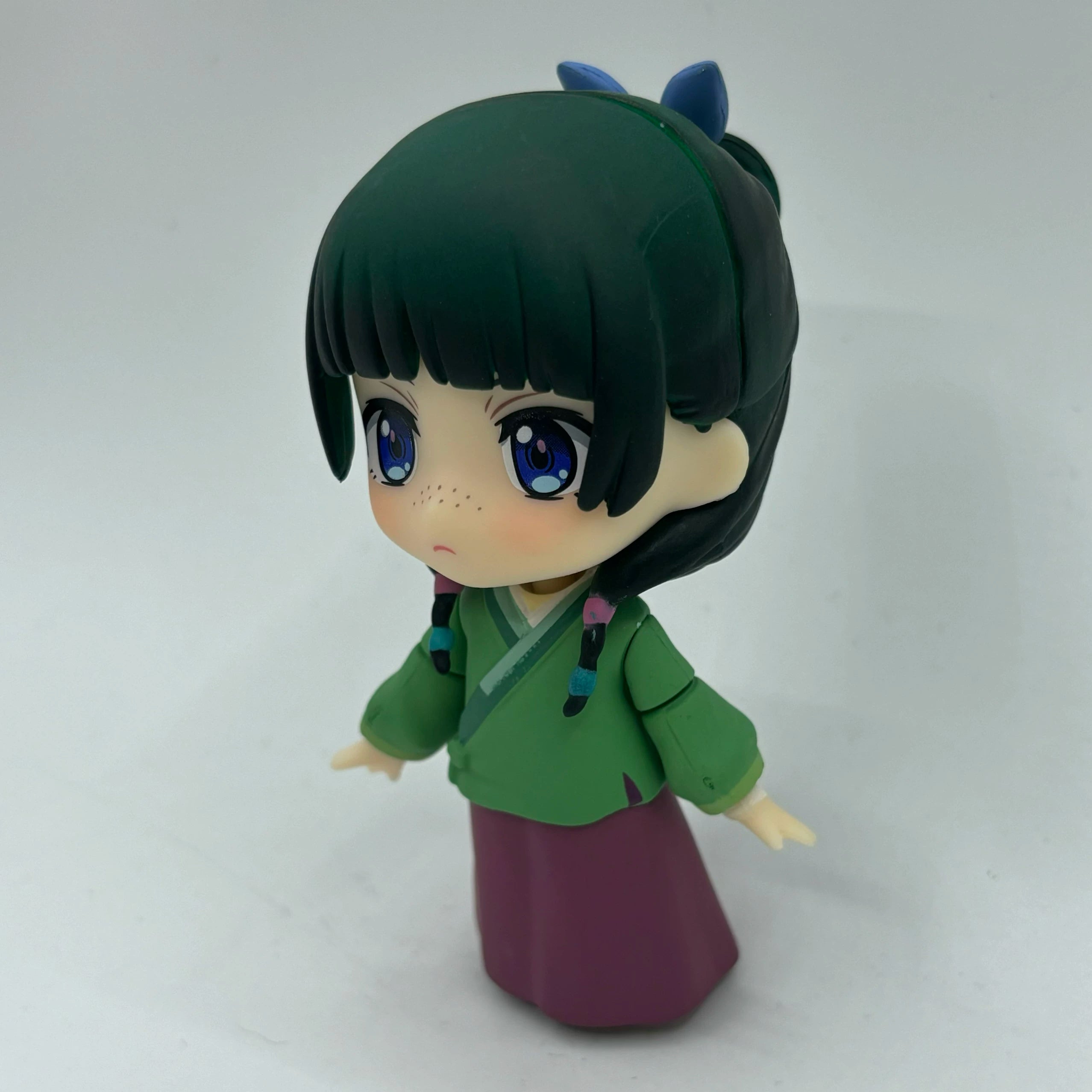 Maomao chibi figure three-quarter view with green top and purple skirt