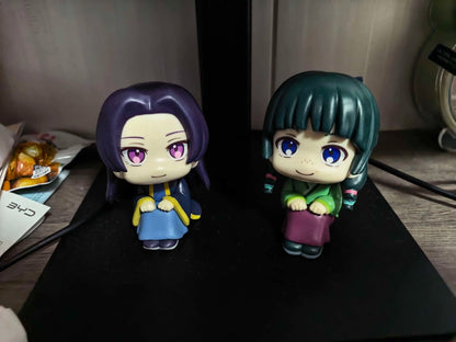 Maomao and Jinshi sitting figures displayed together on a desk